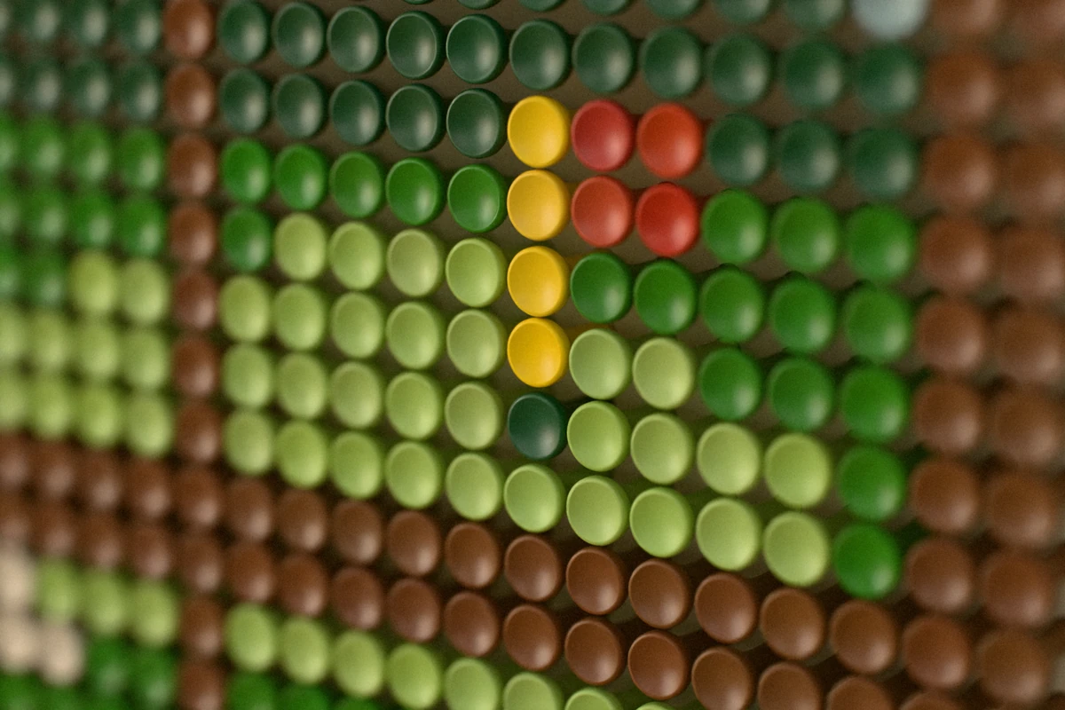 Close-up of the colored tees: the red flag on its yellow pole and the hole on the green, beside the window’s frame.